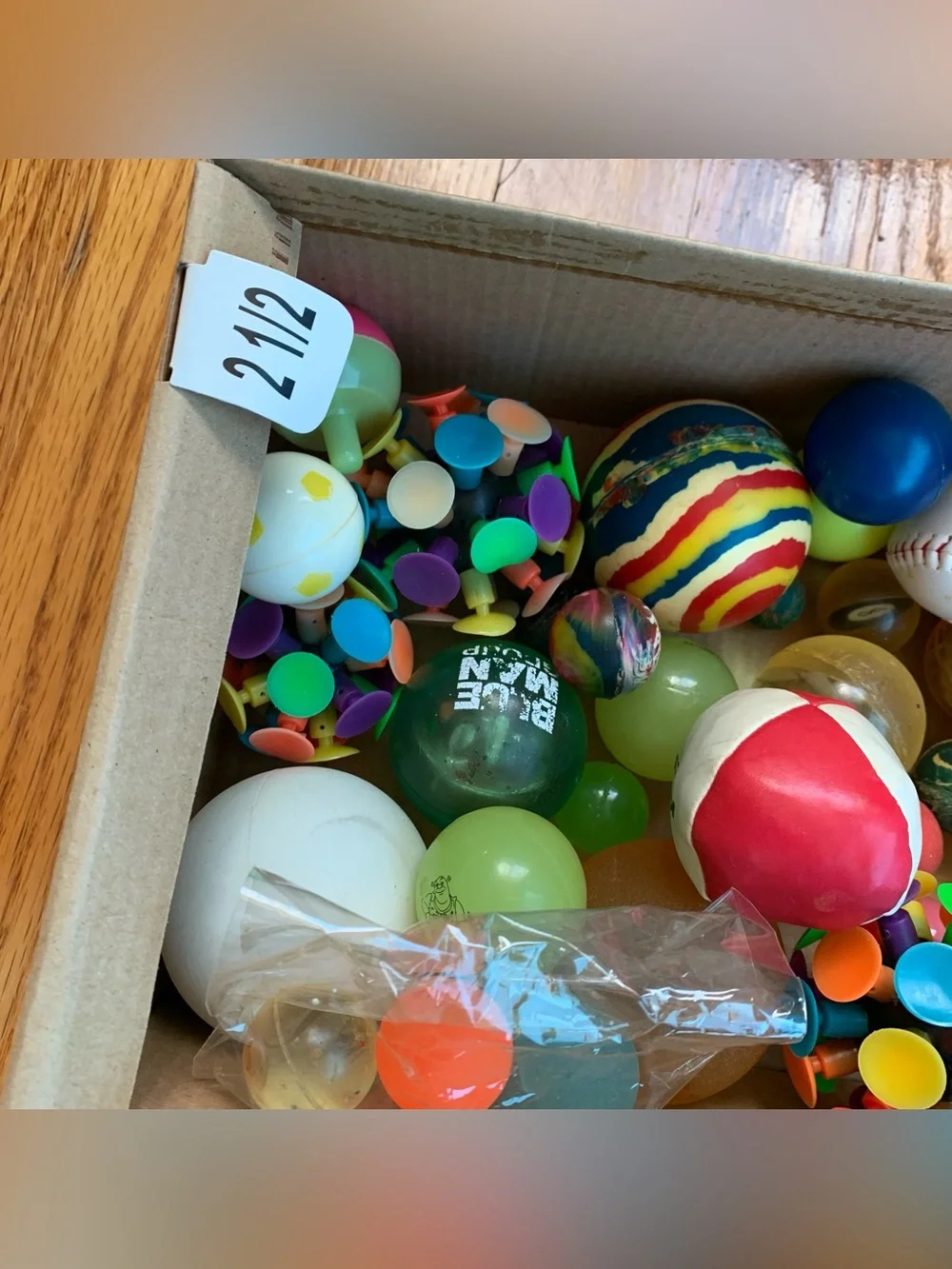 Box of assorted rubber balls, including bouncy balls and vintage Y2K balls